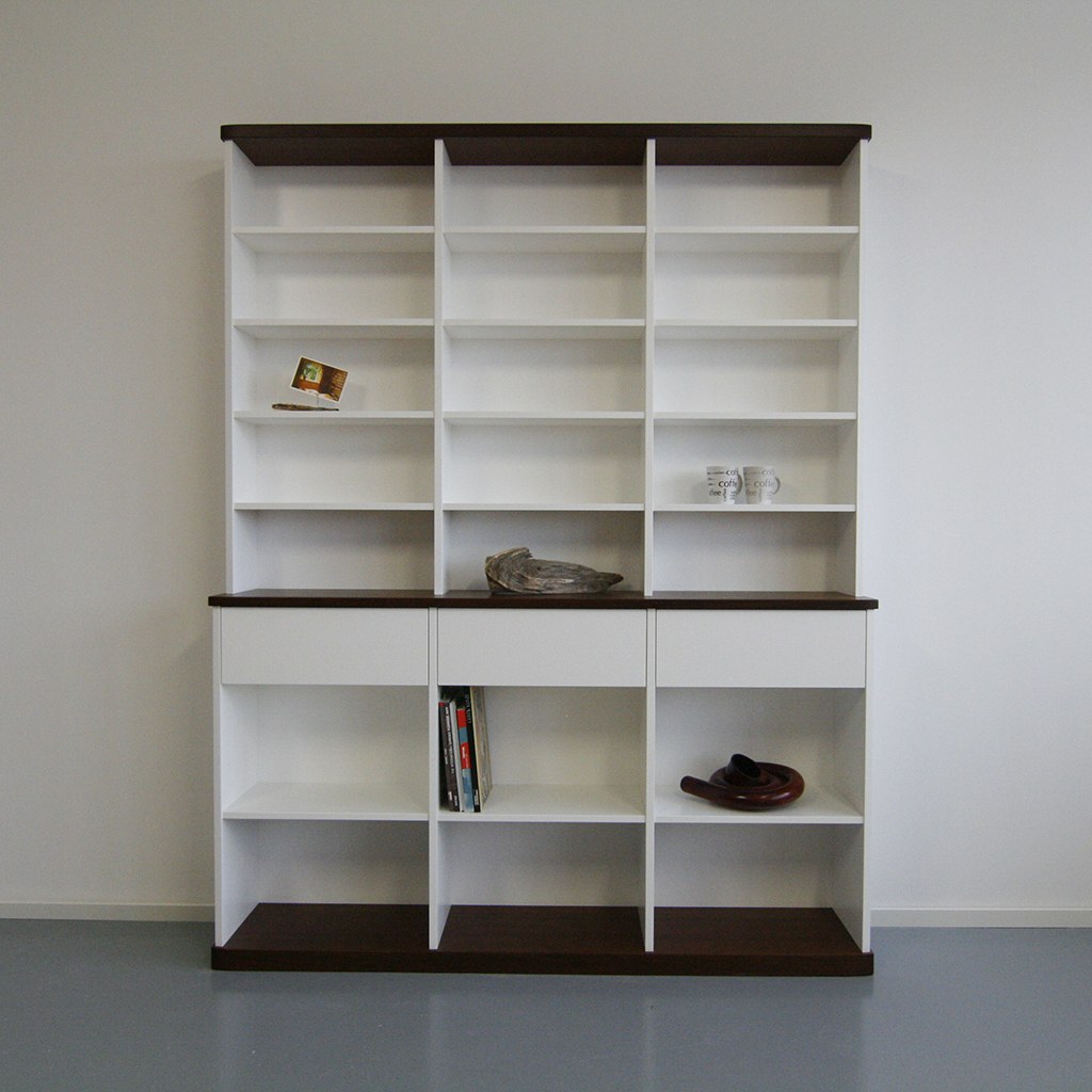 Weißes Bücherregal mit Schubladen und dunklen Holzplatten